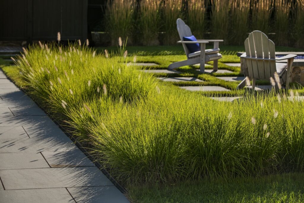 Landscape design with a firepit, plantings, and hardscapes