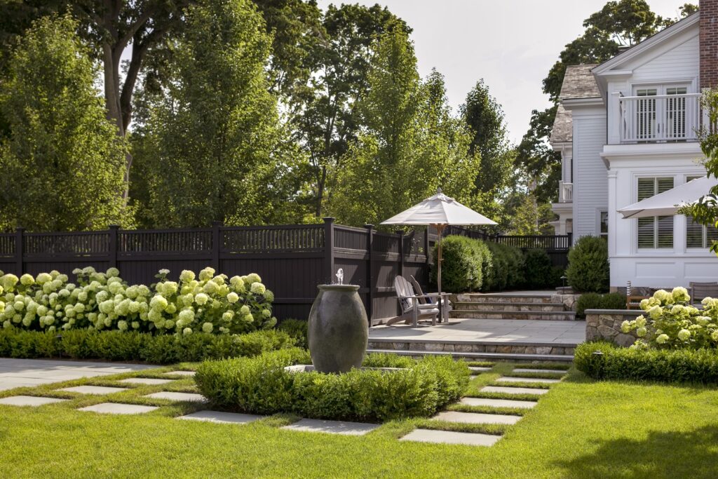 Landscape design with a house, patio, plantings, and hardscapes